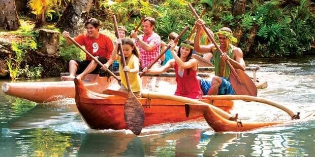 A group of people rowing boats in the water.