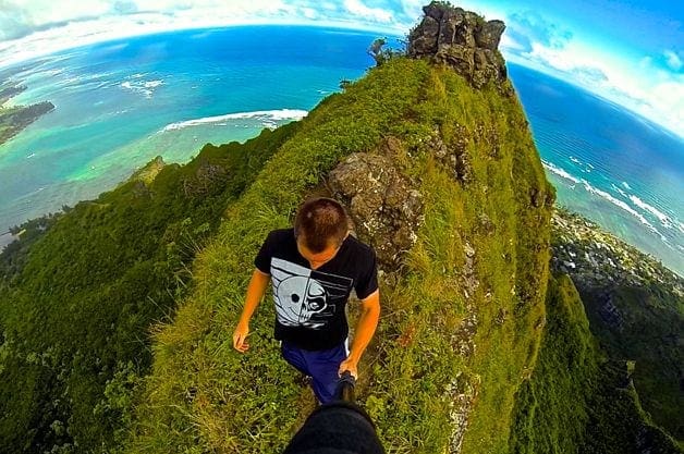 A man is walking up the side of a mountain