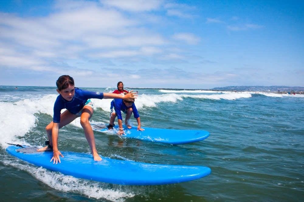 Two people on surfboards in the ocean.