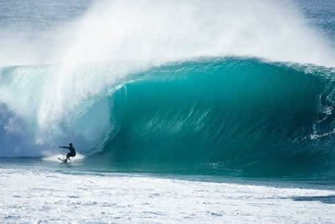 A surfer is riding the waves in the ocean.