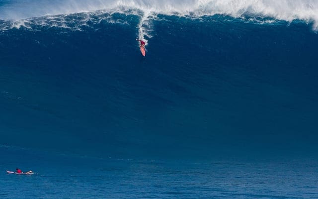 A surfer is riding the waves in the ocean.