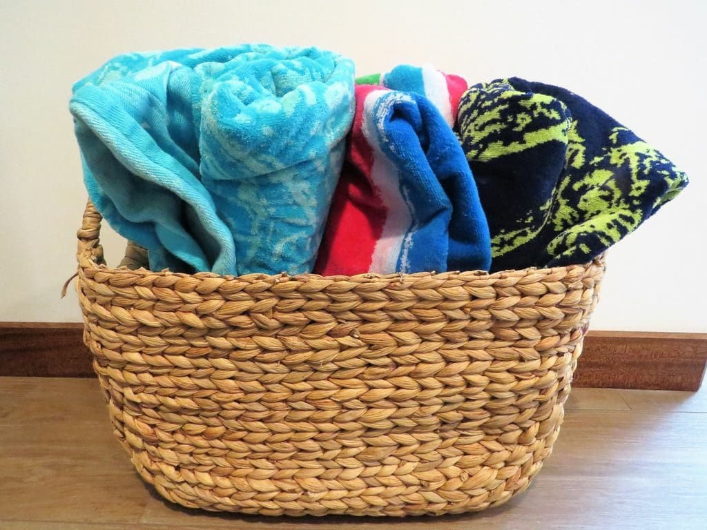 A basket of towels on the floor
