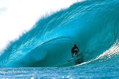 A surfer is riding the waves in the ocean.