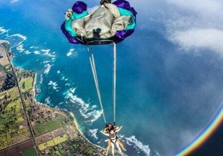 A person is parasailing in the air